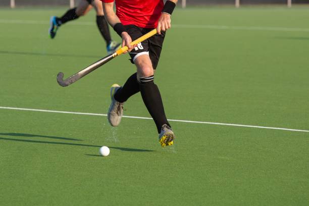istock Field hockey player on artificial grass play field. 1530910290