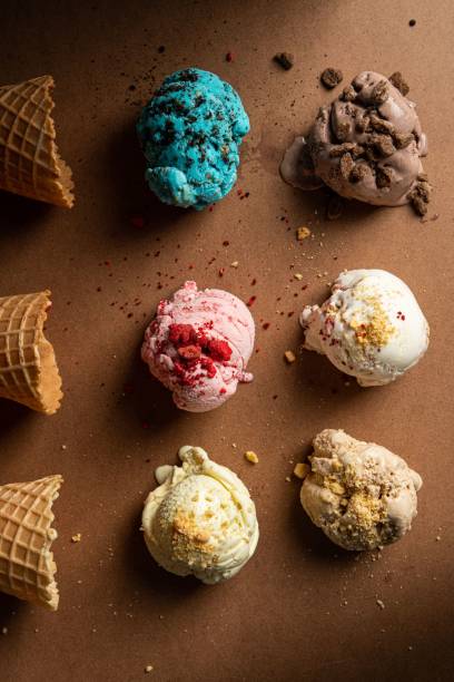 a table with ice cream, fruit and other toppings