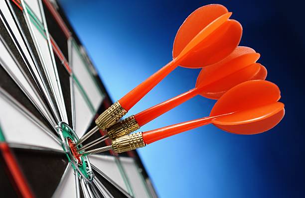 istock Close-up of three red darts in a bullseye 153092245