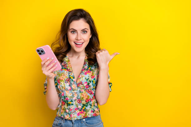 istock Photo of funky funny lady using device pointing finger demonstrate eshop discounts empty space isolated shine color background 1530925195