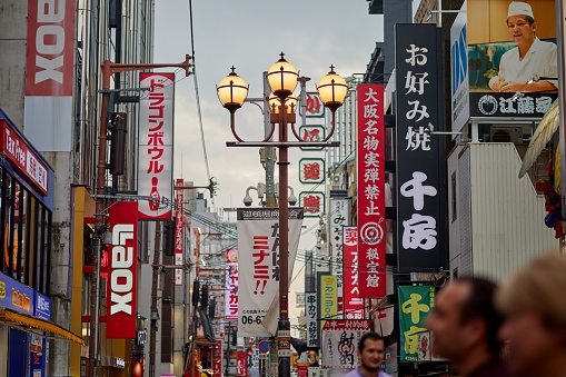 Osaka, Japan – June 26, 2023: A bustling city street filled with colorful signs. Dotonbori Street, Osaka.