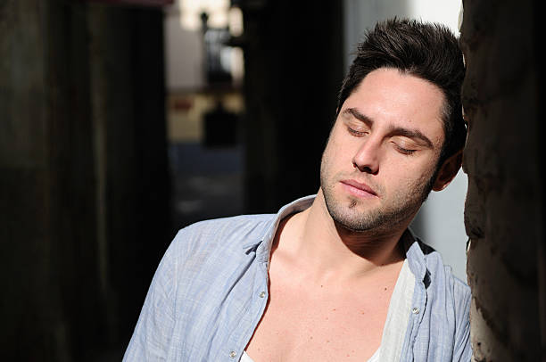 istock Attractive young man in urban background with his eyes closed 153092956