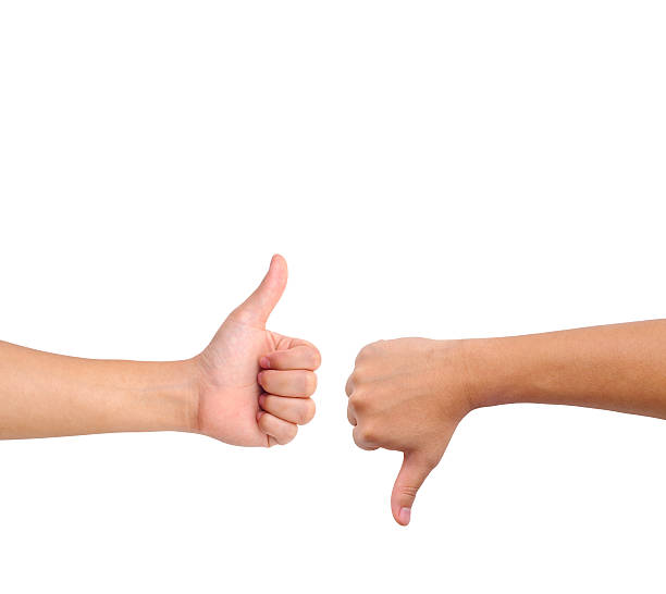 Thumb up and down hand signs Thumb up and thumb down hand signs isolated on white with a copy space thumb down stock pictures, royalty-free photos & images