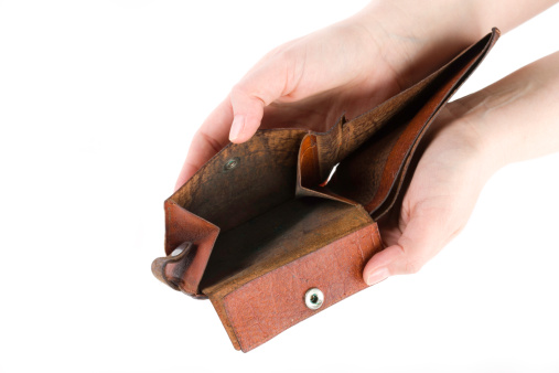 woman's hands holding an old, dirty and empty open wallet