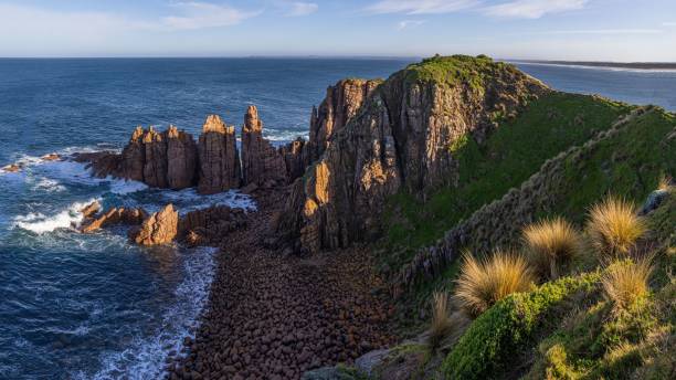 istock a beautiful rock formation and water surrounded by grass and rocks 1530956456