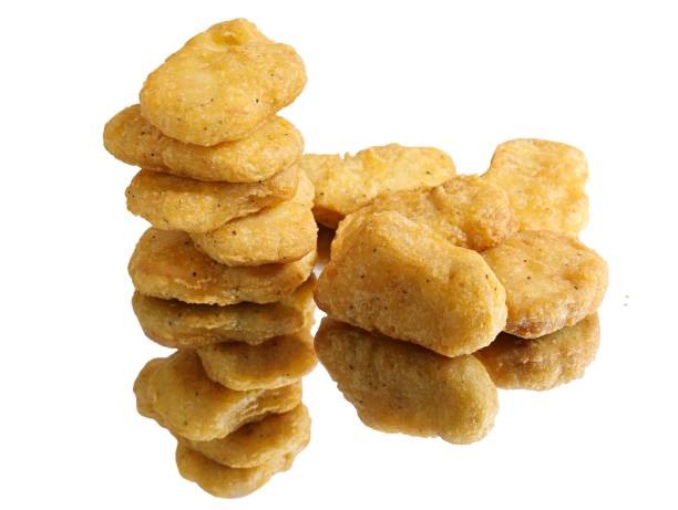 istock Closeup of a stack of chicken nuggets on a reflective white surface 1530958673