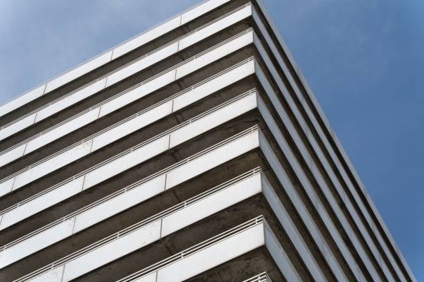 istock Low-angle view of a white building against a blue sky background 1530963477