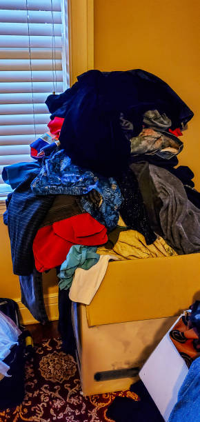 istock Clothes thrown haphazardly mounded up on moving box by window 1530968467
