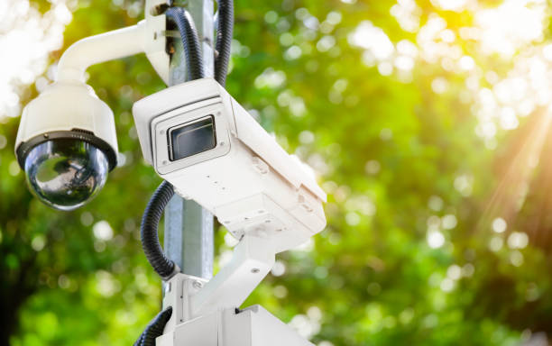 istock Modern public CCTV camera on a electric pole with blurred natural background. 1530969609
