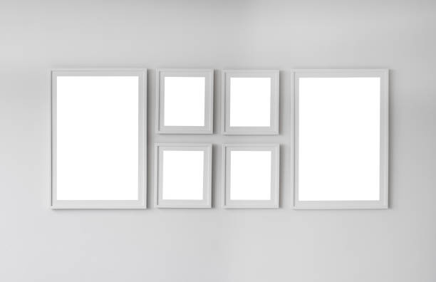 istock Group of blank empty frames on white wall. Photo gallery in interior 1530972285