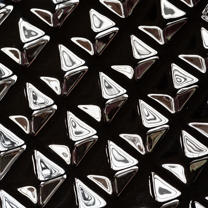 Graphic elements reflected on a metallic cuboid.  
Abstract structures emerge.