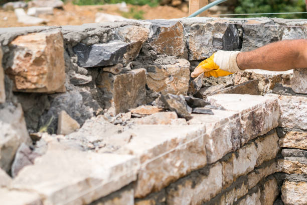 istock Close-up of construction worker builds stone wall 1530973861