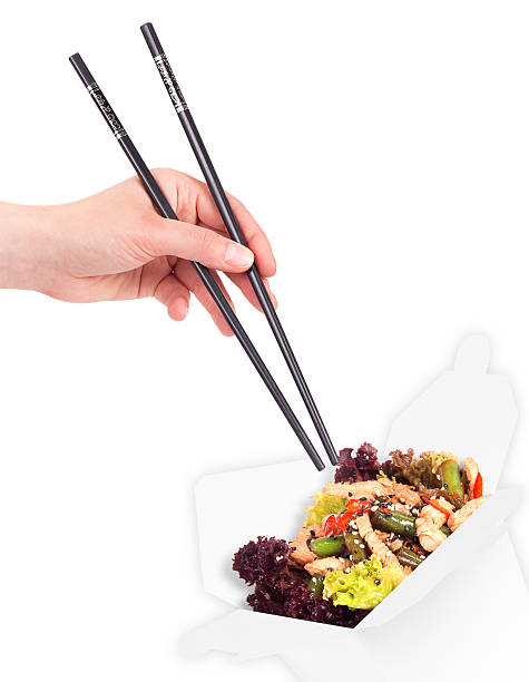 istock Chinese food in a container and hand holding chopsticks 153097531