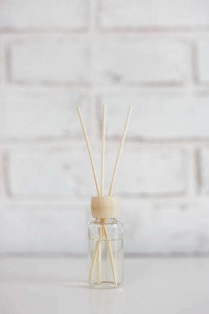istock Home aroma fragrance diffuser with bamboo sticks over white brick wall 1530975820