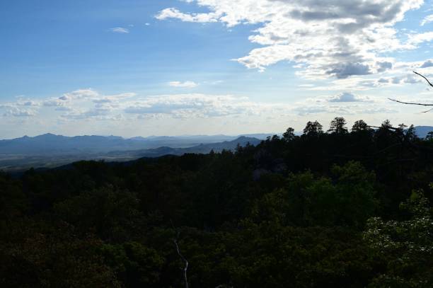 istock clouds in the sky above the trees and mountains are just visible 1530975911