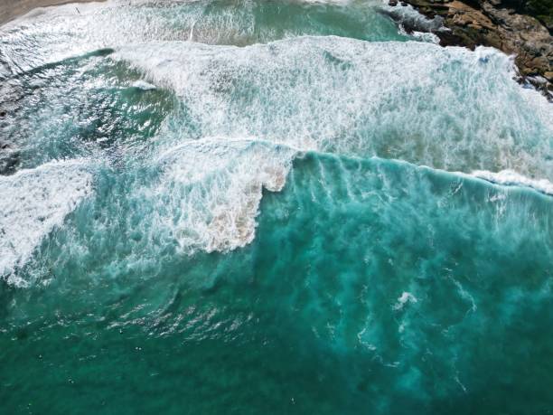 istock Tranquil seascape featuring an ocean with gentle waves lapping against a rocky cliff face 1530976264