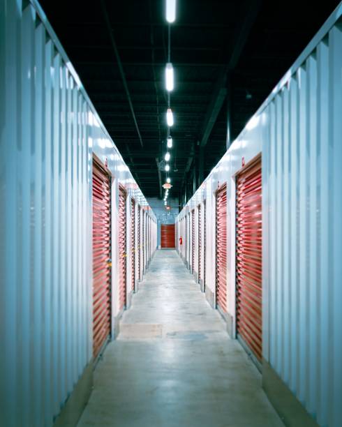 istock Interior hallway of a storage building with red shuttered doors and brick columns along the walls 1530976400