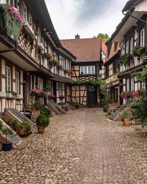 istock an old cobblestone street is lined with old buildings 1530978794