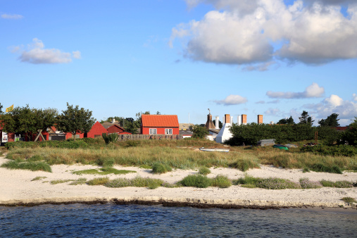 A typical Scandinavian buildings and distinctive white fish smokehouse chimneys - a symbol of Snogebaek, Bornholm, Denmark, Europe