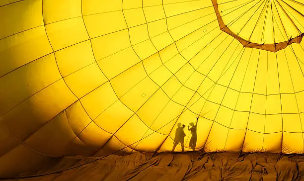 Two little boys touch on the hot air balloon