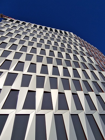 A high-rise office building with a bold, geometric design on its facade