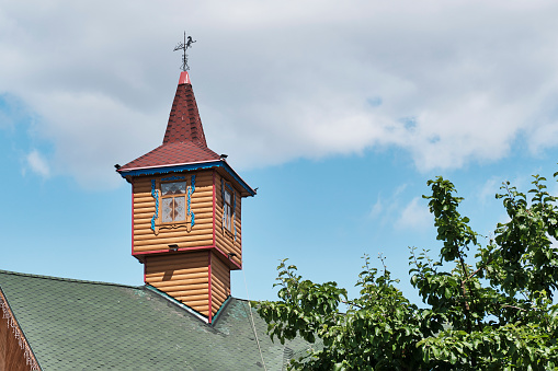 Kazan, Russia - June 8, 2023: Decorative wooden little tower-house on the roof of a building in the national Tatar tourist entertainment complex Tugun Avylym. Travel, architecture concept