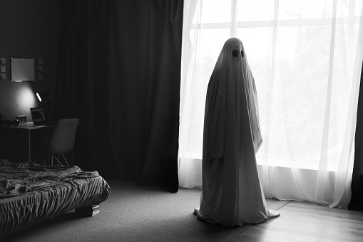 Ghost in bedroom. Horror scene of scary spirit, halloween concept. Copy space
