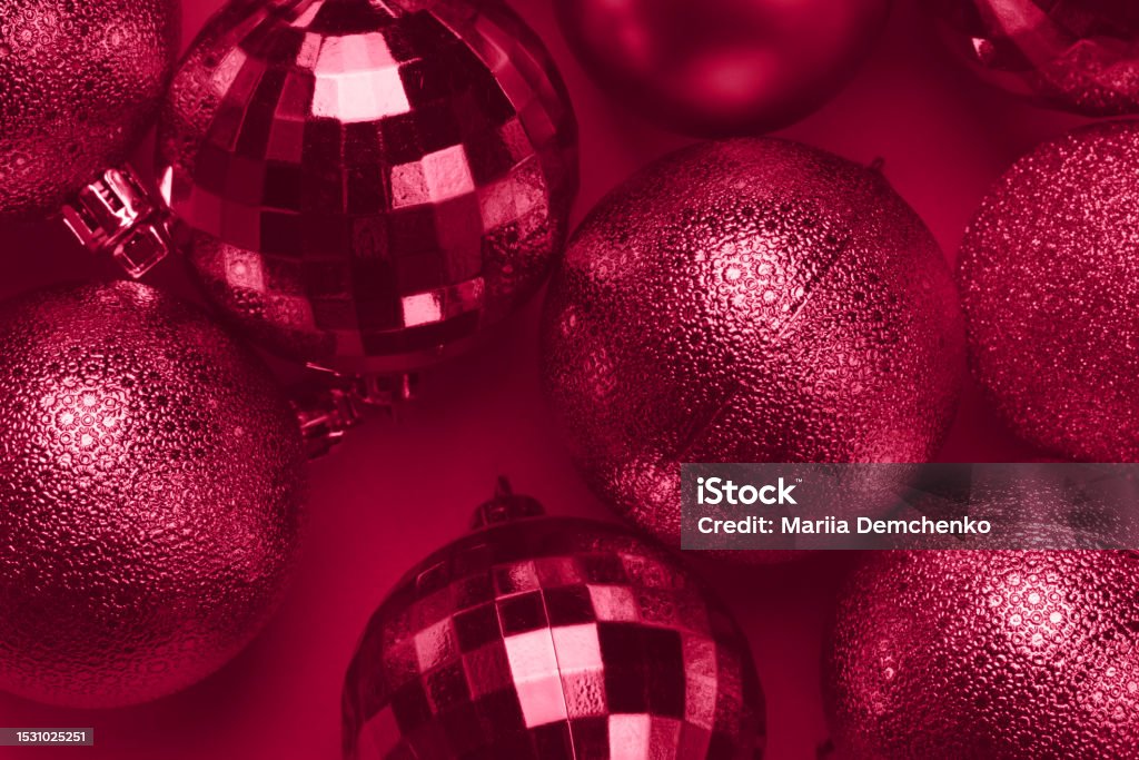 Christmas card with viva magenta balls on carmine red background Christmas card with viva magenta glitter bauble balls on carmine red background Christmas Ornament Stock Photo