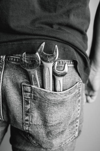 Man hand holding a wrench on white background.