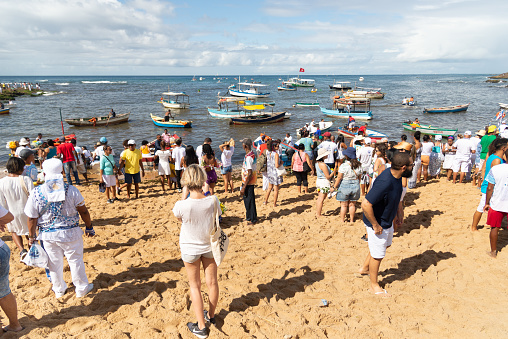 Salvador, Bahia, Brazil - February 02, 2023: Candomble people are seen paying homage to Yemanja on Rio Vermelho beach in Salvador, Bahia.