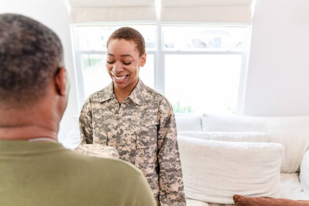 istock Soldier daughter closes eyes as unrecognizable dad presents new cap 1531059465