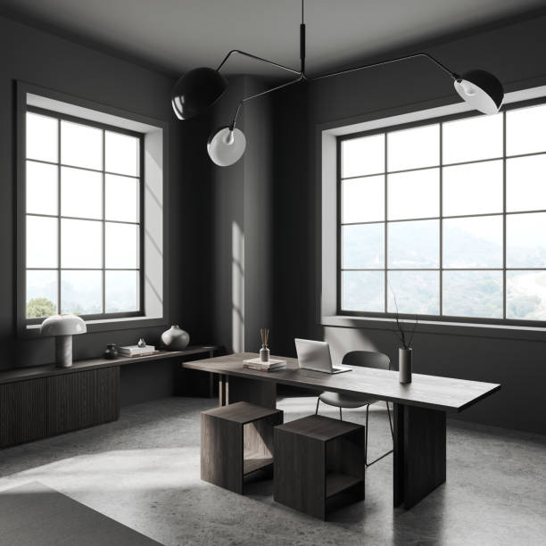 istock Grey workplace interior with laptop on table and decoration on sideboard, window 1531070184