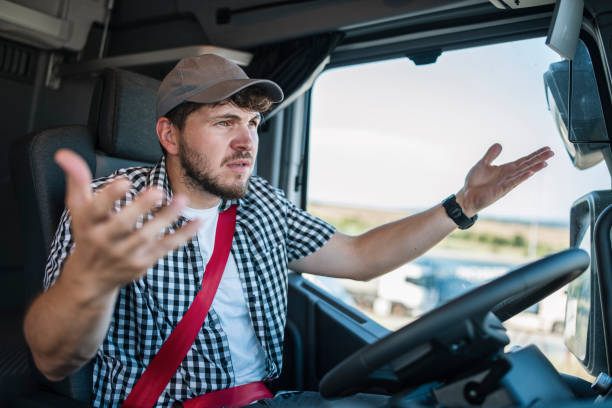 istock Trucker angry about bad drivers on the road. 1531074619