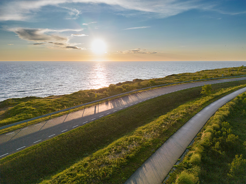 Road near the cliff of the Paldiski peninsula in summer at sunset, photo from a drone. High quality photo