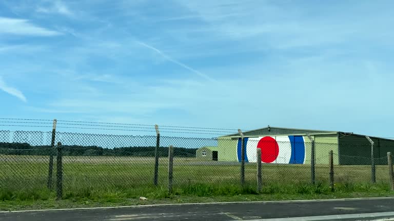 RAF airfield behind wired fence view from moving car