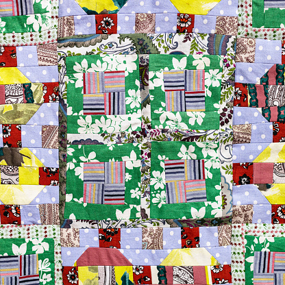 textile background - detail of handmade square patchwork quilt