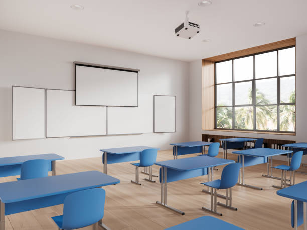 istock Cozy class room interior with table in row and blackboard with screen, window 1531080578