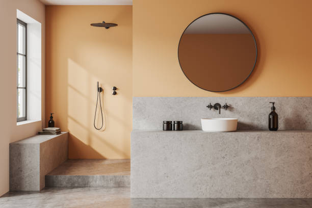 istock Stylish hotel bathroom interior with sink and shower, partition and window 1531097018