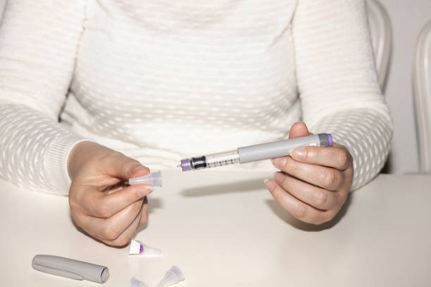 istock Woman holding an injection pen for diabetic. 1531097026