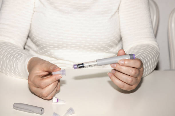 Woman holding an injection pen for diabetic. Insulin injection pen or insulin cartridge pen for diabetics. Medical equipment for diabetes parients. Woman holding an injection pen for diabetic. wegovy stock pictures, royalty-free photos & images