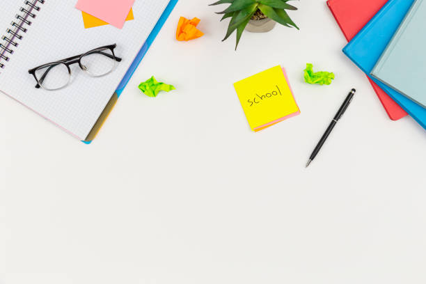 istock Notebooks, glasses and paper reminders on a white background, top view. 1531103011