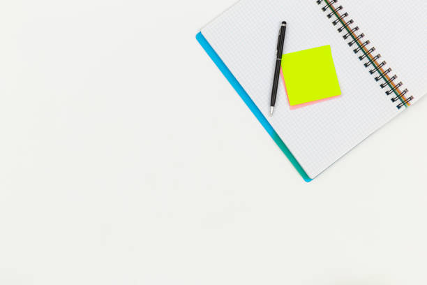 istock Notebook, pen and paper colored reminders on a white background. 1531103029