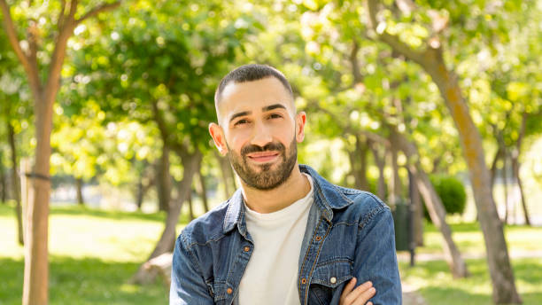 istock Happy young man looking directly at camera in natural setting 1531124213