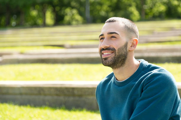 istock Smiling young bearded man looking at photo's copy space 1531124217