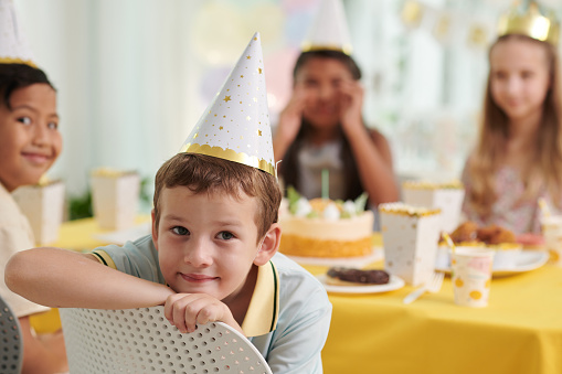 Portrait of smiling preteen boy attending birthday party
