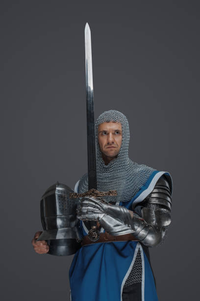 istock Proud knight stands holding his sword and helmet 1531146076