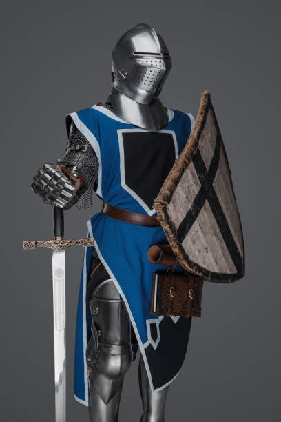 istock Medieval knight in blue surcoat holding a sword and shield 1531146877