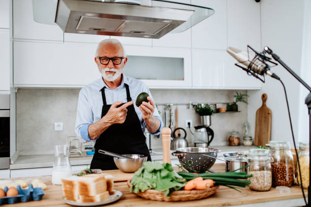 istock Handsome senior chef working as food vlogger 1531173729