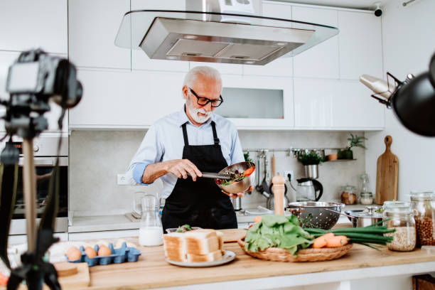 istock Handsome senior chef working as food vlogger 1531173931