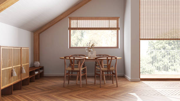 istock Minimal wooden dining room with sloping ceiling and window in white tones. Classic table and chairs. Japandi scandinavian style, attic interior design 1531174149